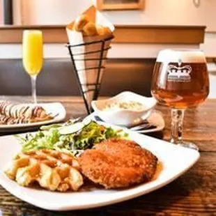 a plate of food and a glass of beer