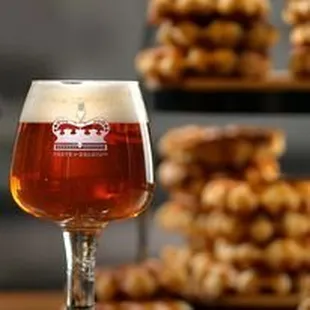 a glass of beer and a stack of cookies