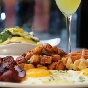 a plate of food and a glass of wine