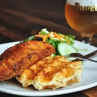 a plate of food and a glass of beer