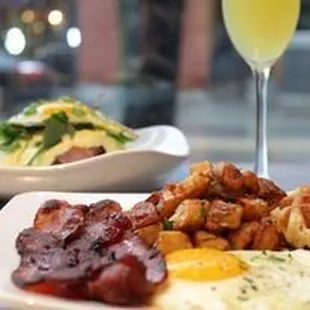 bacon, eggs, hash browns, and a glass of champagne