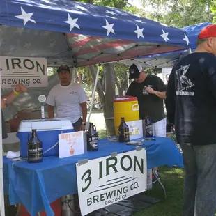 a group of people standing under a tent
