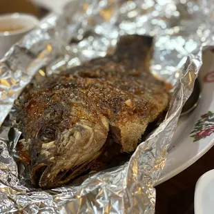 a whole fish wrapped in tin foil