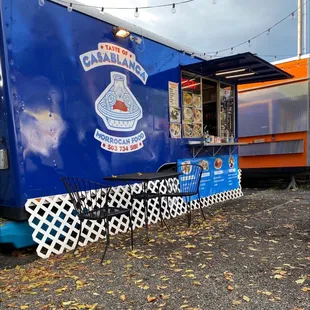 a blue food truck parked in a parking lot