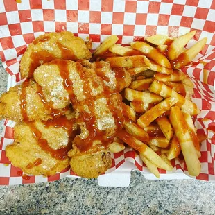 Four piece chicken tender with fries and Chicago style lemon pepper and mild sauce.