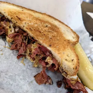 Half of the pastrami sandwich.