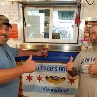 two men giving thumbs up