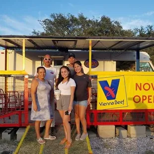 a group of people standing in front of a food truck