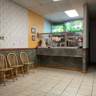 a restaurant counter and chairs