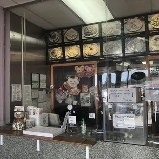 Contactless delivery system, partial menu items and their contactless payment station along with printed menus to take home.