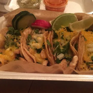 Chicken tacos with cheese, onion, and cilantro
