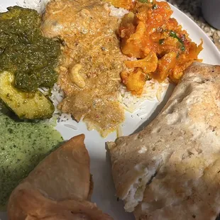 Aloo Gobi, chicken Korma, Saag paneer, garlic naan, and vegetable samosa
