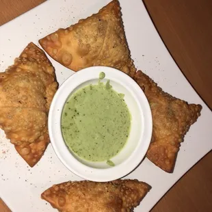 a bowl of sauce on a plate