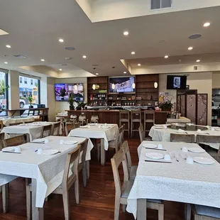 a dining area with tables and chairs