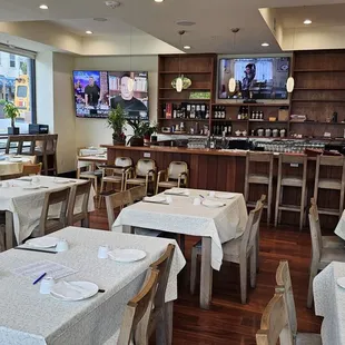 a dining area with tables and chairs