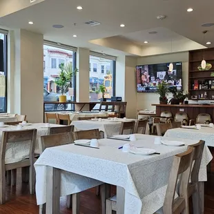 a dining area with tables and chairs