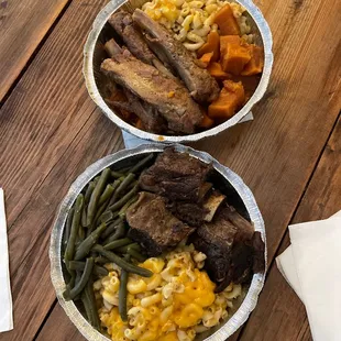 two bowls of food on a wooden table