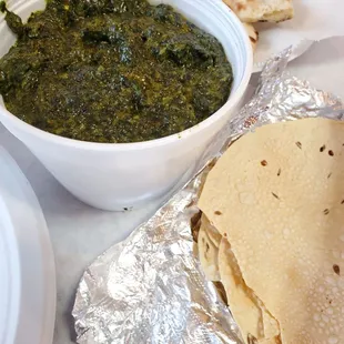 a bowl of spinach and tortillas