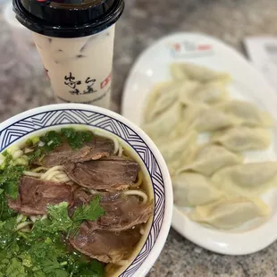 Beef noodle soup , pork and sour cabbage dumplings, milk tea