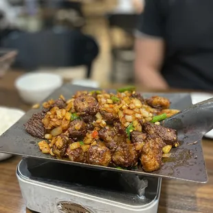 Cumin lamb served on hot iron plate