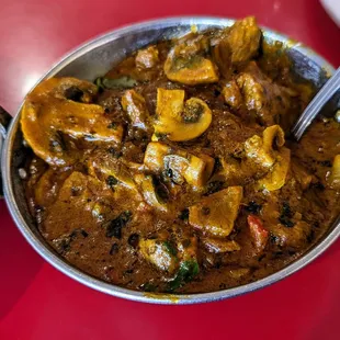 a bowl of curry and a plate of rice