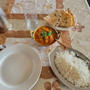 a plate of rice and a bowl of curry