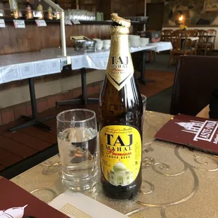 a bottle of beer and a glass of water