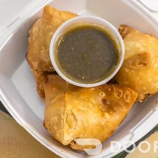 a bowl of sauce and some fried food