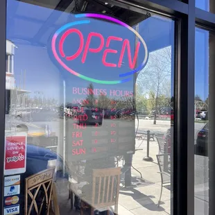 open sign in window of business