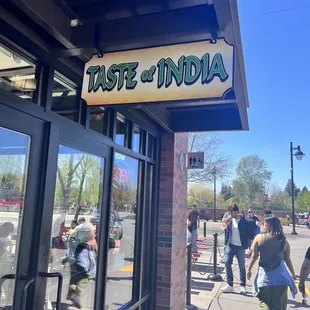 people walking in front of a restaurant