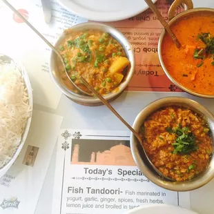 three bowls of food on a table