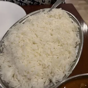 a plate of rice and a bowl of curry