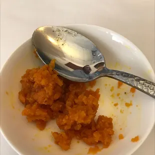 a bowl of food with a spoon