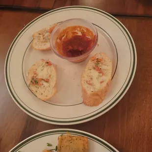 a plate of bread and dipping sauce