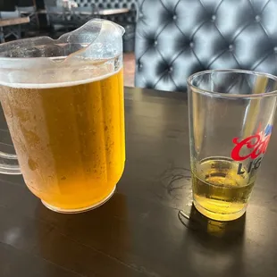 Tall cold coors light in a comfortable  newly upholstered booth!