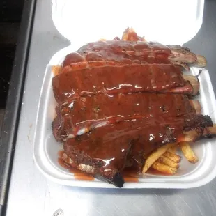  ribs and fries in a styrofoam container