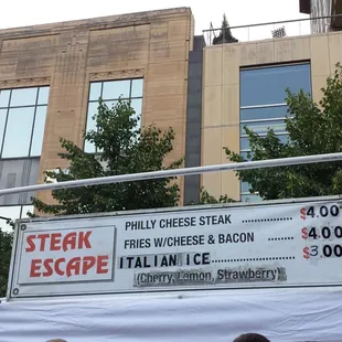 a steak escape sign in front of a building