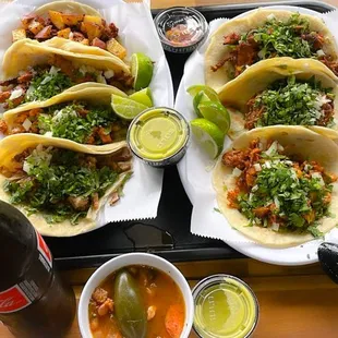 a tray of tacos and a drink