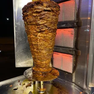 This meat gets cooked in slow vertical grill to get cooked right and to get the juicy meat taste