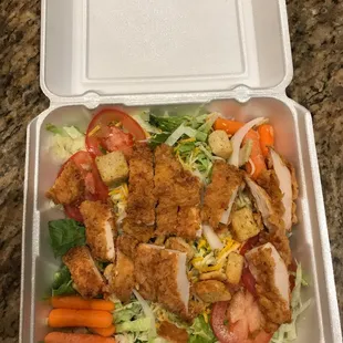 a salad in a styrofoam container