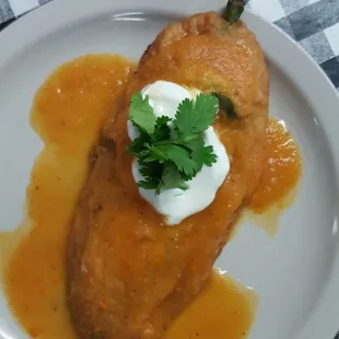 Chile Relleno / stuff poblano pepper with cheese cover in our house red sauce