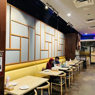 a woman sitting at a table in a restaurant