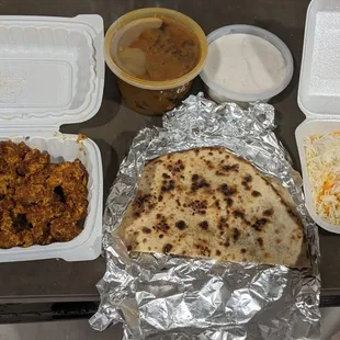 Double order of chicken 65 (BOGO), tamarind eggplant curry, raita, garlic naan, included rice. Naan wasn&apos;t my favorite