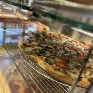 a pizza in a glass case