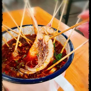 3 squid skewers part of the Old Chengdu Spicy Pot