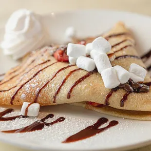 a crepe with chocolate sauce and marshmallows