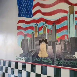 a mural of a flag and a bell