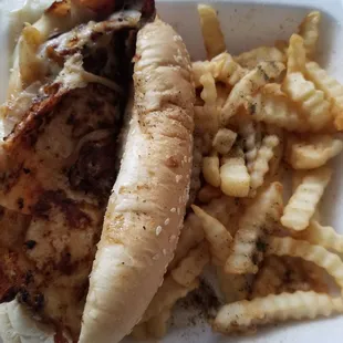 Chicken philly sandwich with fries.
