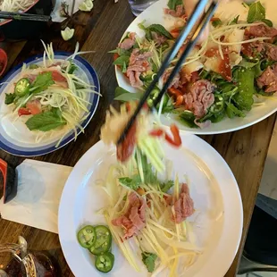 Custom papaya and green mango salad with rare steak and surf clam.