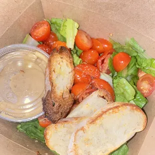 Side salad with balsamic and some bread slices.